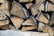 firewood background of chopped wood for kindling and heating the house Close-up. a woodpile with stacked firewood. the texture of the birch tree. banner