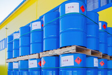 Barrels With Chemical Products. Casks Stored Outdoors. Pallets With Blue Barrels Near Warehouse. Containers With Flammable Products. Metal Barrels With Toxic Substances. Casks Near Chemical Factory