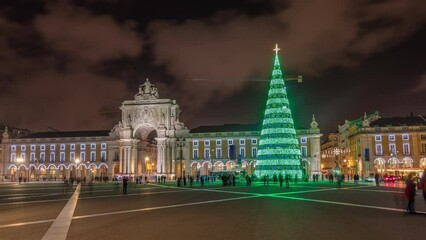 Poster - Commerce square illuminated and decorated at Christmas time in Lisbon night timelapse hyperlapse. Commercio square with christmas tree and people tourists crowd around, city of europe