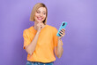 © deagreez - Portrait of minded clever girl dressed stylish clothes look at smartphone read interesting post isolated on violet color background