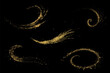 Gold glitters on a black background. Wavy elements set. Shine of gold dust.