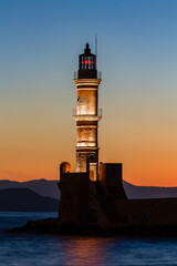 Wall Mural - Old Venetian lighthouse with a colorful sunset (Chania, Crete, Greece)