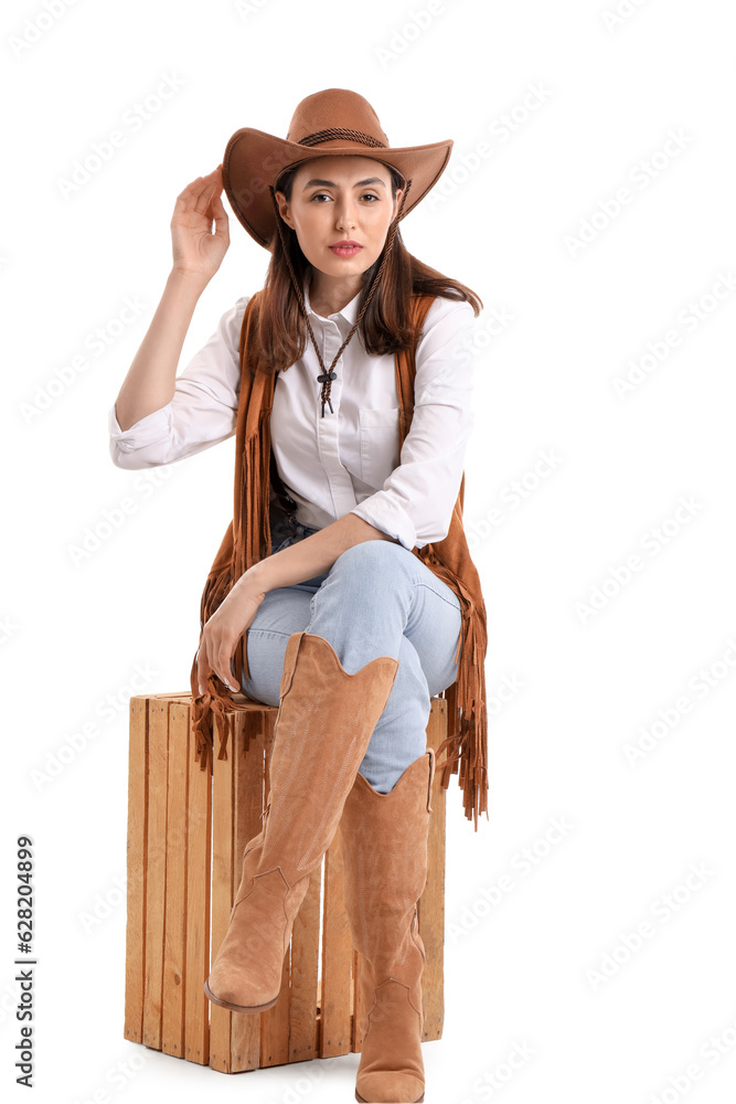 Beautiful cowgirl sitting on white background