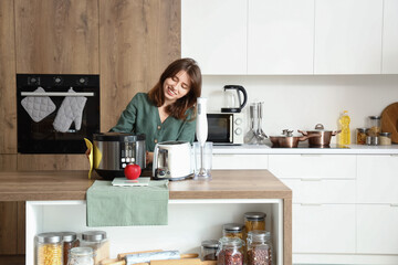 Sticker - Young woman cleaning electric multi cooker in kitchen