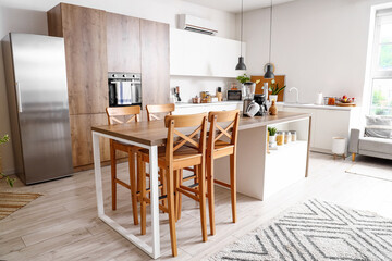 Wall Mural - Interior of light kitchen with modern appliances on wooden table