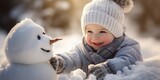 Fototapeta  - Cute Baby boy and snowman in winter background. Kid during stroll in a snowy winter park. Active outdoors leisure with family with children in winter, generative ai