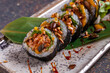 Sushi roll with eel, nori, cucumber and sesame seeds
