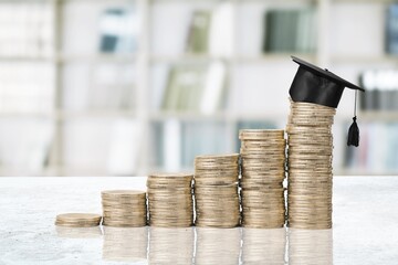 Student and financial concept, black Graduation cap and coins