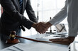 © crizzystudio - The handshake after a good cooperation, consulting between attorney and client, businessman, tax and real estate project company.