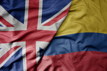 Big Waving National Colorful Flag Of Great Britain And National Flag Of Colombia .
