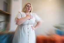 Overweight Plus Size Young Woman Feel Chest Pain At Home. Heart Attack Concept.