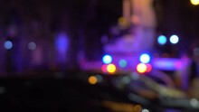 Defocus Bokeh Of Rescue Workers With Police And Ambulance Lights.