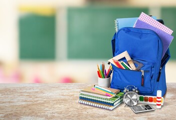 Wall Mural - Different school colored supplies on table in classroom