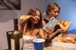 © SuperStock - Female College students eating pizza and talking on phone
