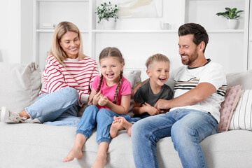 Canvas Print - Happy family having fun together on sofa at home