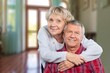 © BillionPhotos.com - Senior couple hug in living room