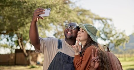 Wall Mural - Interracial, couple and selfie, camping in nature with happiness and social media post with friends. Live streaming, peace hand sign and memory, black man and woman outdoor with smile in picture