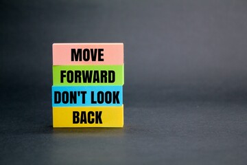 colored paper with the words move forward don't look back. the concept of self-motivation. the conce