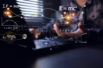 student holding physics and math equations it floating from the laptop computer screen, representing