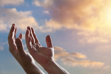 Canvas Print - Human hands worship Praying on sky background