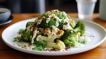 Fresh Broccoli And Cauliflower Salad With Tahini Dressing On Plate