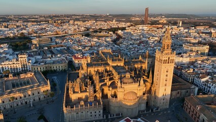 Gorgeous sunrise in Seville, Spain. Aerial shot of Seville city center with gothic cathedral and famous Giralda bell tower