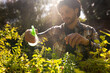 © Wavebreak Media - Happy indian man watering plants in sunny garden