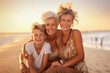© Kalim - AI generated image of grandmother with grandchildren on beach