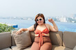 © Charlie's - Overweight young asian woman wearing swimsuit relaxing in the pool Happy plus size woman cheery funny Vacation Traveling in summer.