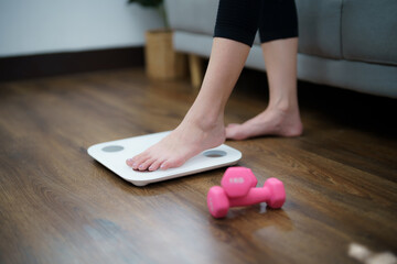 Wall Mural - Fat diet and scale feet standing on electronic scales for weight control. Measurement instrument in kilogram for a diet control