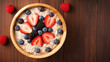 Healthy overnight oat topping with fresh fruit on table.