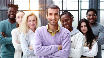 Wall Mural - Group of business people standing at the window of a modern office