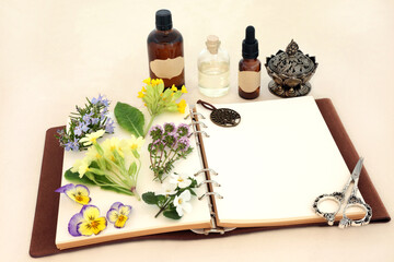 Canvas Print - Naturopathic herbal medicine preparation with flowers, herbs and essential oil bottles with notebook. Natural spring floral nature concept for flower essences and remedies on hemp paper.