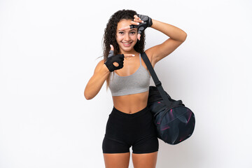 Wall Mural - Young sport Arab woman with sport bag isolated on white background focusing face. Framing symbol