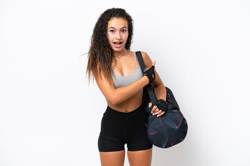 Wall Mural - Young sport Arab woman with sport bag isolated on white background surprised and pointing side