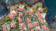 Gorgeous private villas with orange roofs and ocean views next to the beach. Aerial top down view of luxury oceanfront pool villas. Comfortable rest and privacy 2