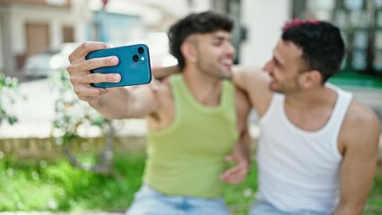 Sticker - Two men couple smiling confident having video call at park