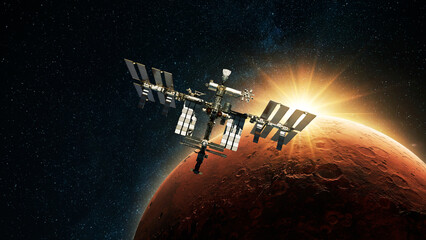 Wall Mural - iss spacecraft flies against the backdrop of dawn light and red planet mars with craters in deep spa