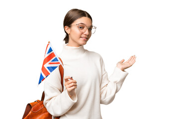 Canvas Print - Teenager student caucasian girl holding an United Kingdom flag over isolated background extending hands to the side for inviting to come