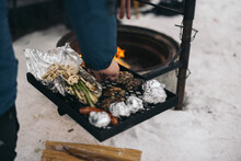 Crop Hiker Preparing Vegetables And Meat On Grill In Snow