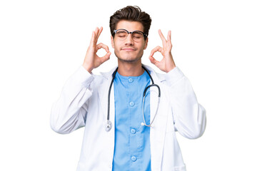 Wall Mural - Young doctor man over isolated background in zen pose