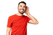 © luismolinero - Young handsome caucasian man over isolated chroma key background listening to something by putting hand on the ear
