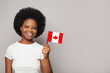 © millaf - Canadian woman holding flag of Canada Education, business, citizenship and patriotism concept