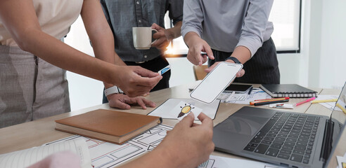 A close-up of an ux ui developer and an ui designer working on a mockup icon interface for a mobile app