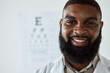 Optometrist, face and portrait of man with smile with trust for eye care services, healthcare consultation and clinic assessment. Happy African optician with pride for medical analysis of eyes
