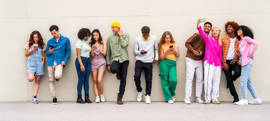 happy playful multiethnic group of young friends bonding outdoors - multiracial millennials students