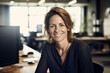 © Six Hen Media - Friendly female smiling professional businesswoman sitting at her desk in the office.