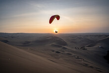 Paragliding During The Sunset In The Huacachina Oasis In Ica, Peru