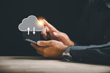 Innovative technology is at the businessman's fingertips as he touches the cloud icon. Experience the seamless connection and access to information on a cloud computing platform.