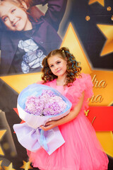 Beautiful and happy teenage girl in a fancy pink dress for pop star parties.